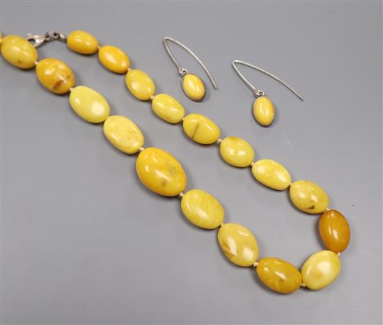 A single strand graduated amber bead necklace and pair of similar earrings, gross weight 36 grams, necklace 53cm.